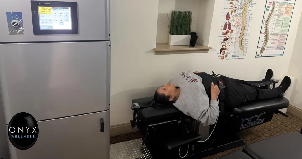 an Onyx Wellness patient receives a spinal decompression treatment on a specialized chiropractic table