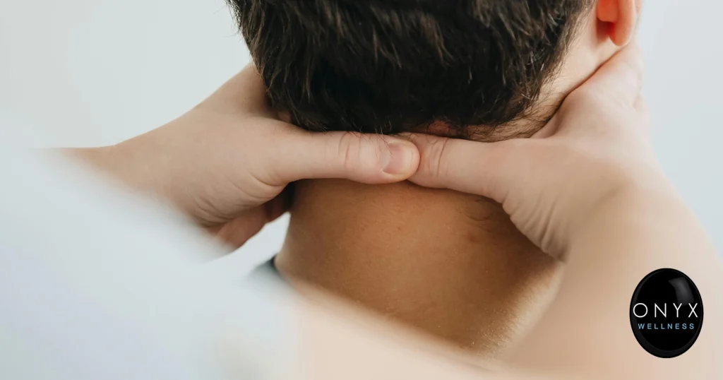 Chiropractor applying manual therapy to the cervical spine and neck of a male patient