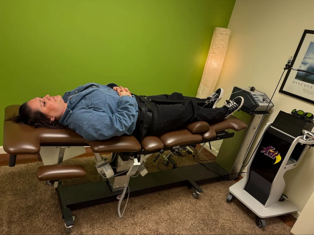 Female chiropractic patient receiving a spinal decompression treatment to ease back pain at Onyx Wellness