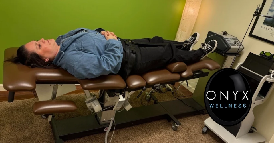 female chiropractic patient laying on a spinal decompression table