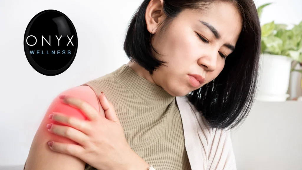 woman holding her right shoulder, which is hurting due to inflammation