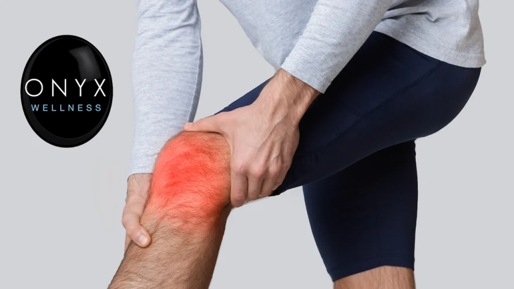 Person holding a painful, inflamed knee highlighted in red, representing chronic knee pain and inflammation