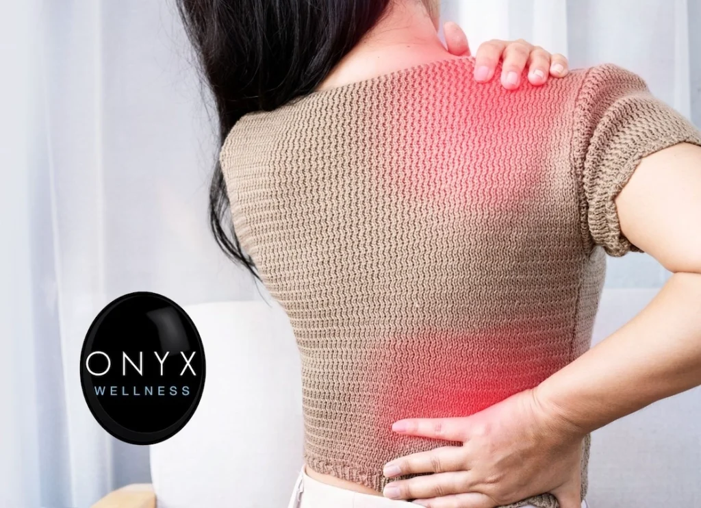 woman holding her right shoulder and lower back, which are aching due to inflammation